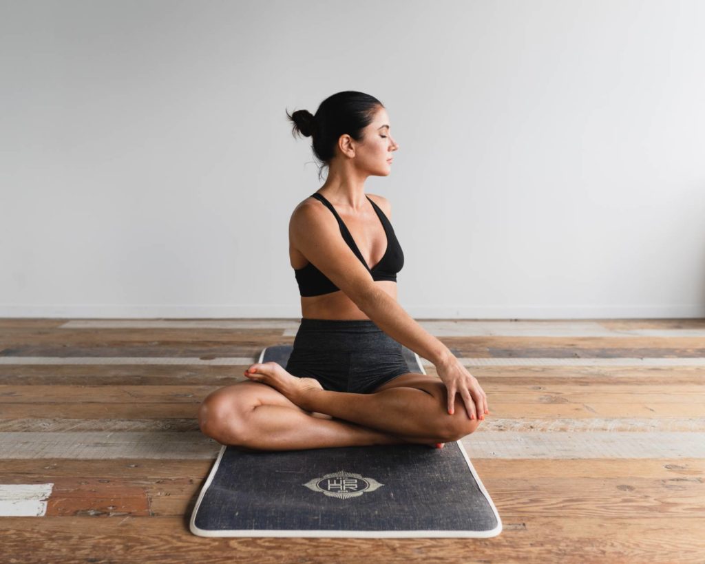 Woman alone on yoga mat